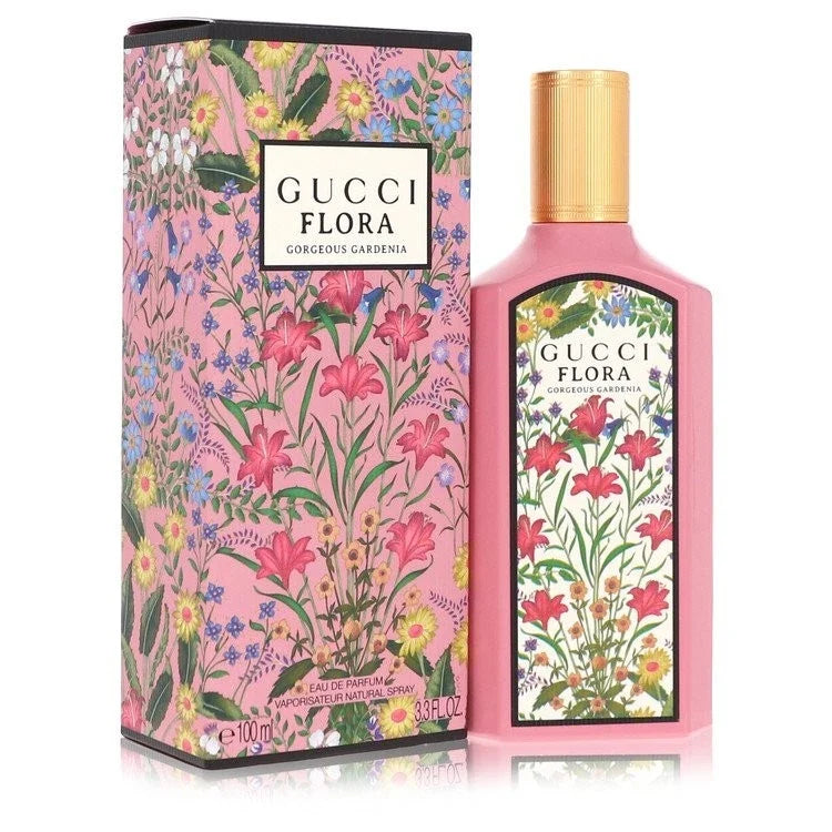 Gucci Flora Eau de Parfum bottle and its matching outer packaging box, both decorated with a vibrant pink, green, and multicolor floral pattern, on a white background.