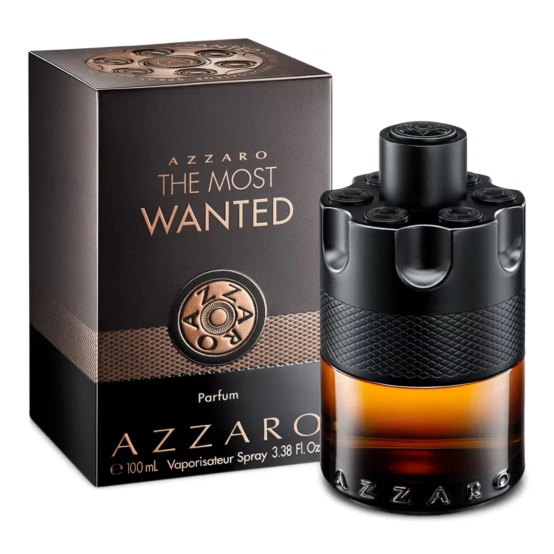 Azzaro The Most Wanted Parfum shown with its retail box. The bottle is black with a textured middle band and a warm amber-brown liquid inside, next to a matching black and brown box with gold lettering.