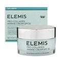 Elemis Pro-Collagen Marine Cream SPF 30 in a clear glass jar with a silver lid, shown in front of its light blue and teal packaging box.
